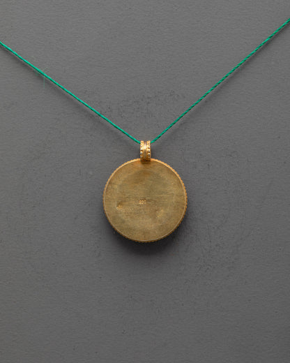 Back view of Endless Knot Locket revealing smooth copper base and artisan craftsmanship