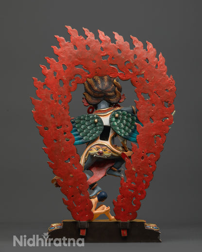 Back view of Garuda Statue with carved wings and blazing halo background