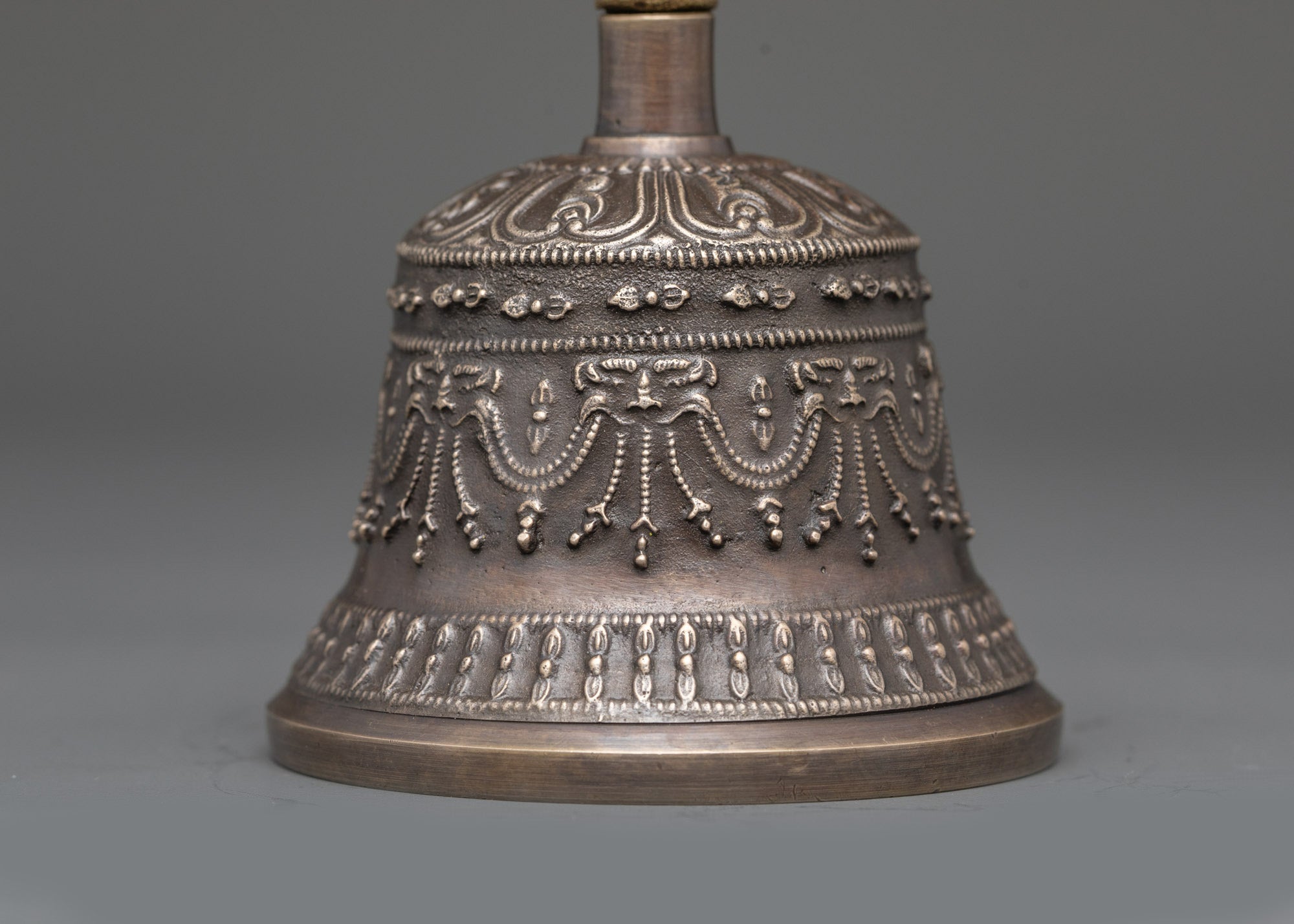 Back view of Ghanta Dorje set on altar showing bronze craftsmanship and sacred symbols