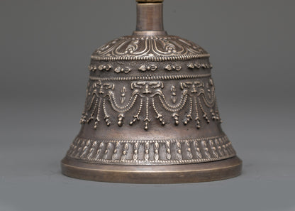 Back view of Ghanta Dorje set on altar showing bronze craftsmanship and sacred symbols