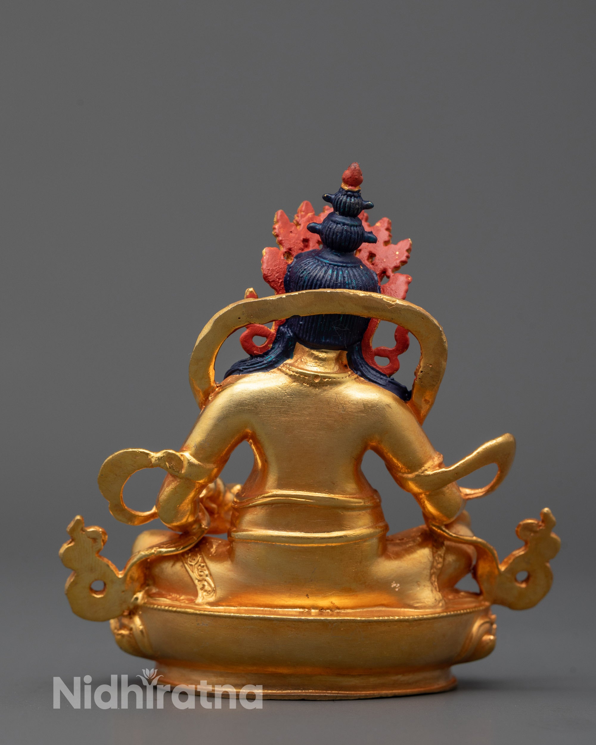 Back view of Golden Dzambhala Statue with traditional lotus seat