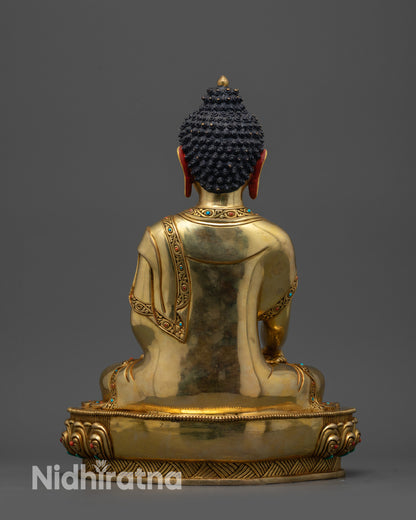 Back view of Golden Shakyamuni Buddha statue highlighting detailed lotus and robe patterns