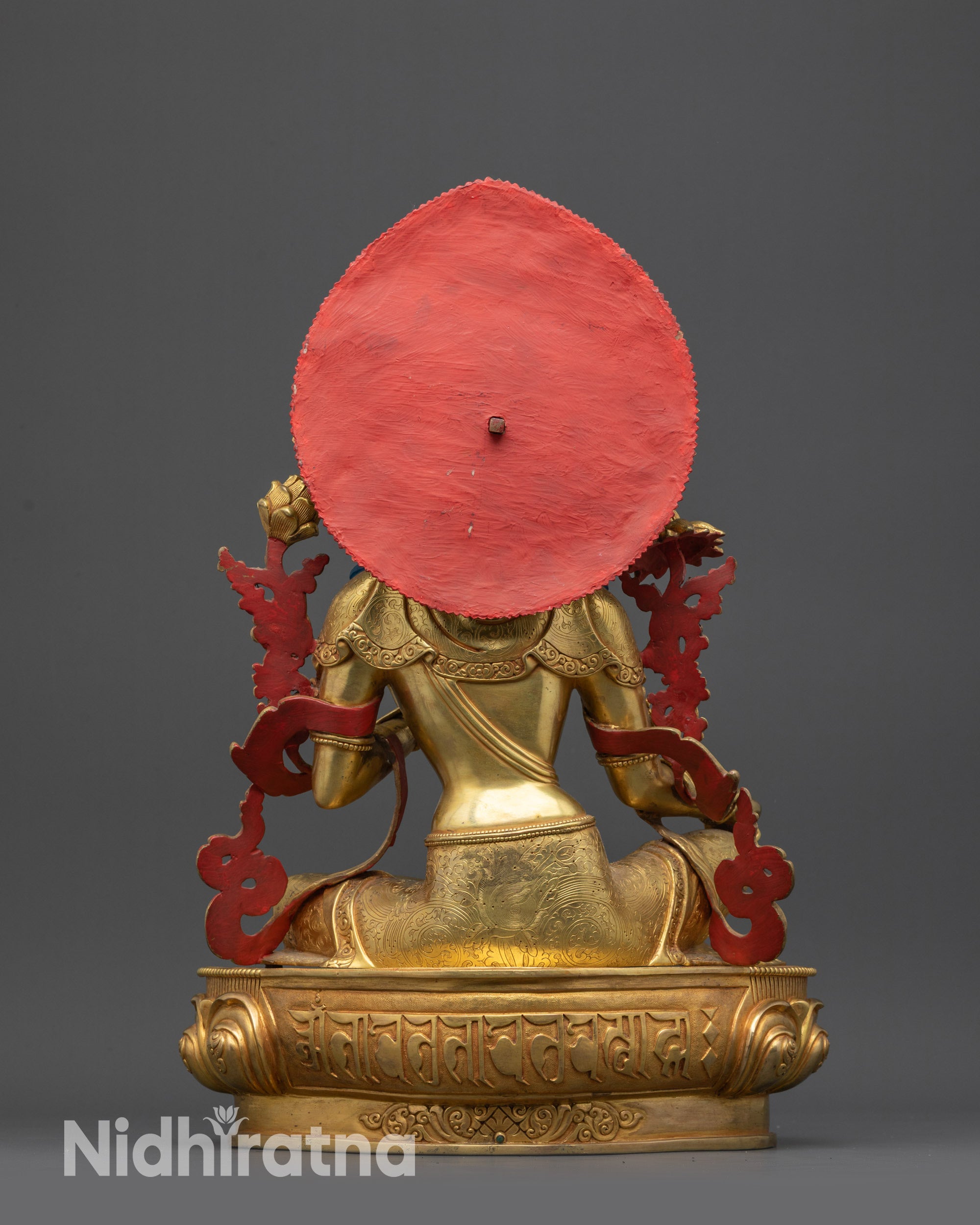 Back view of Green Tara idol highlighting carved patterns and royal ease posture
