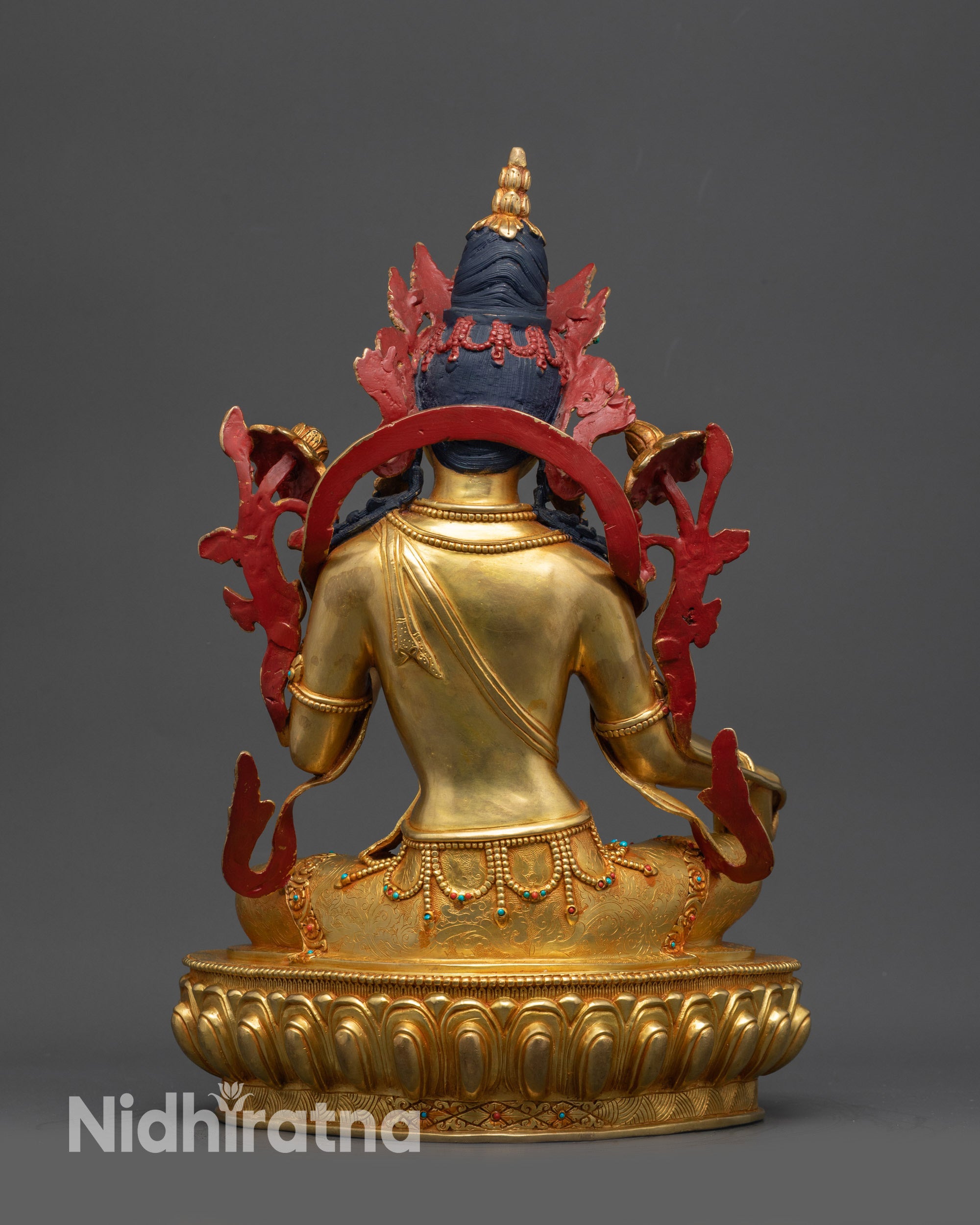 Back view of Green Tara statue highlighting detailed robes and lotus base