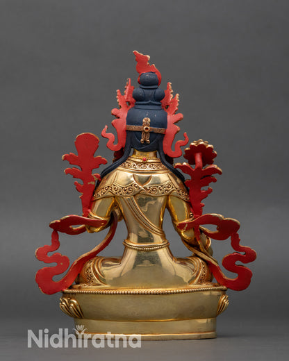 Back view of Green Tara statue, intricate lotus throne and carved robes