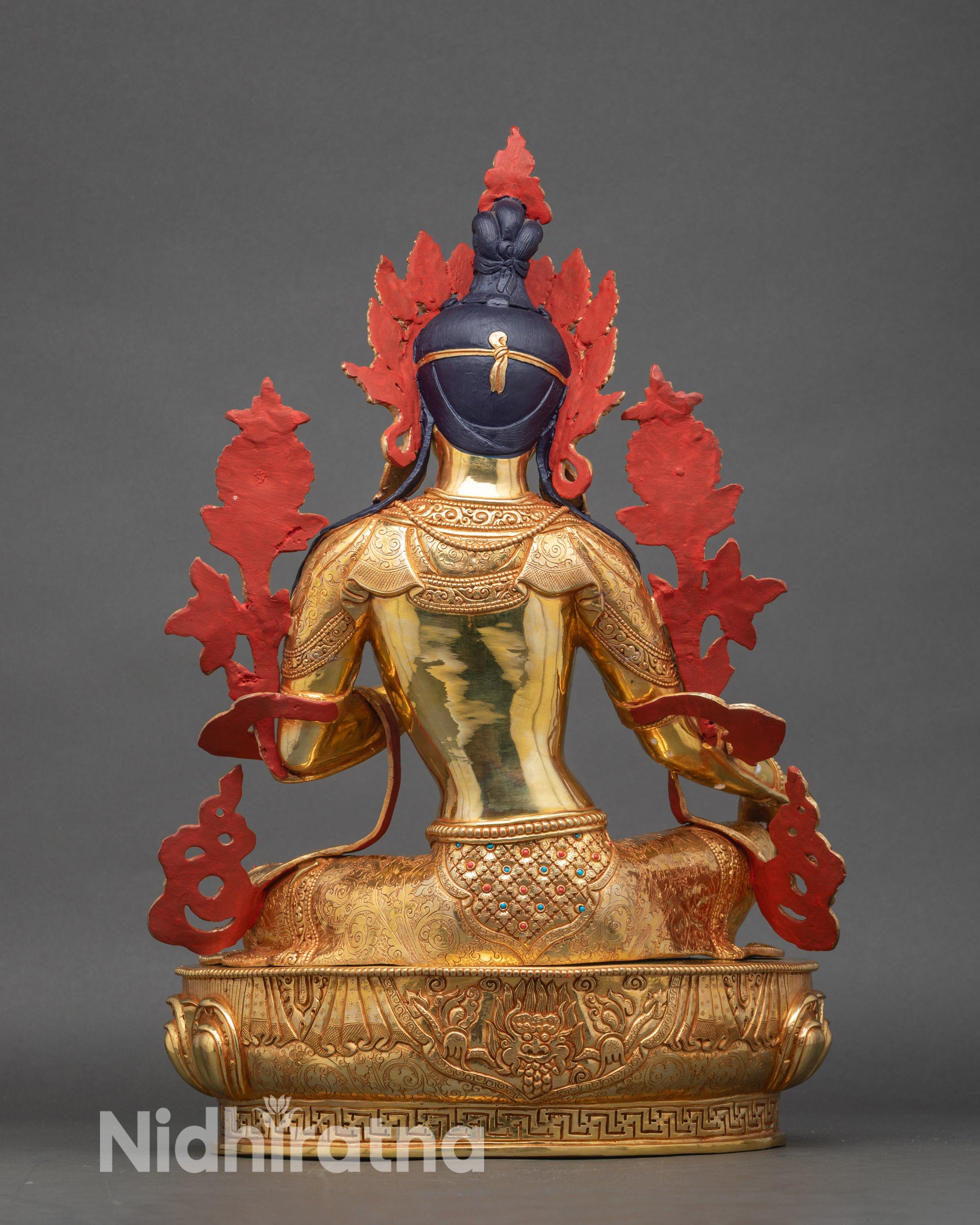 Back view of Green Tara statue revealing lotus pedestal and detailed hand-carved decorations