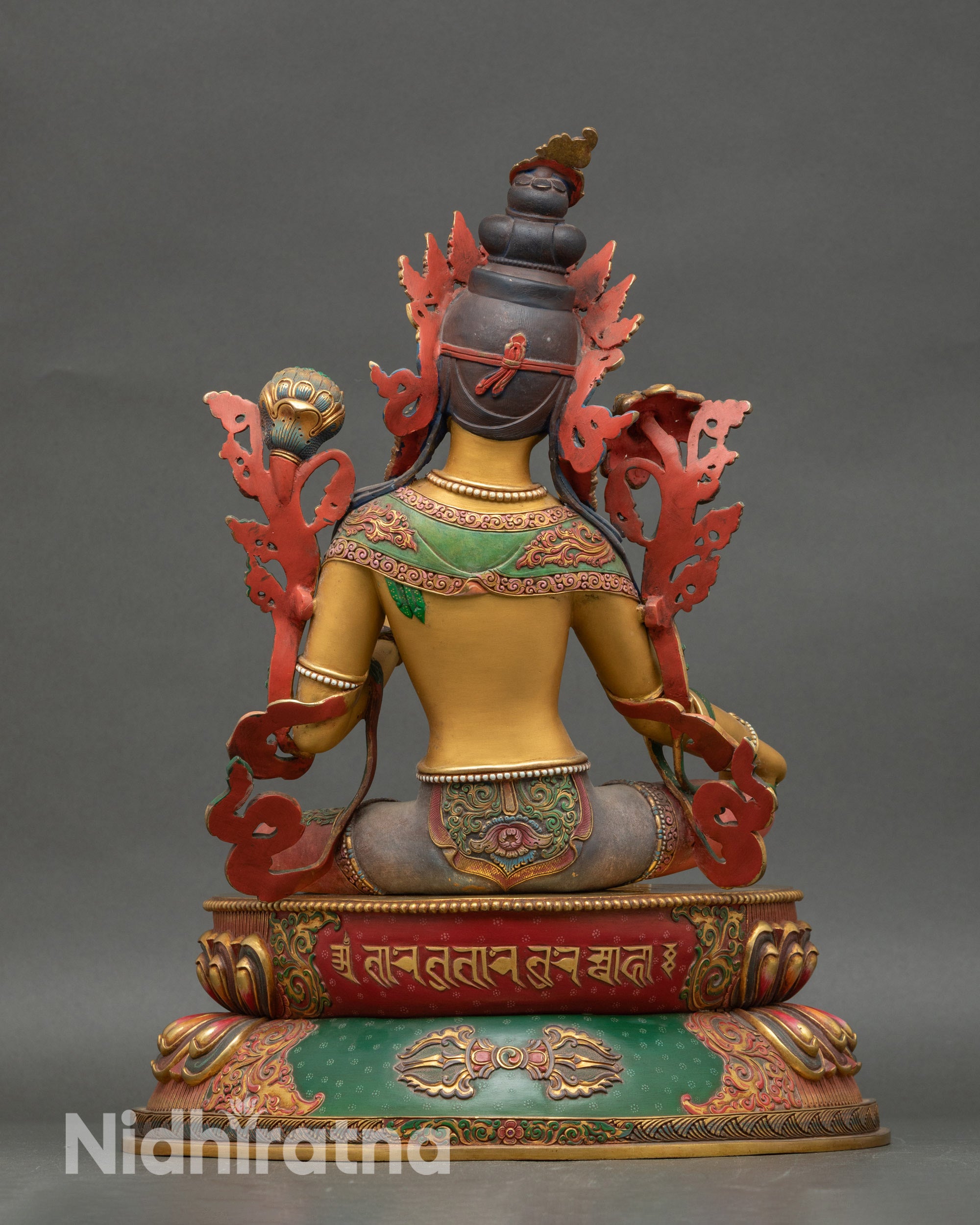 Back view of Green Tara statue showing detailed floral robes and lotus pedestal