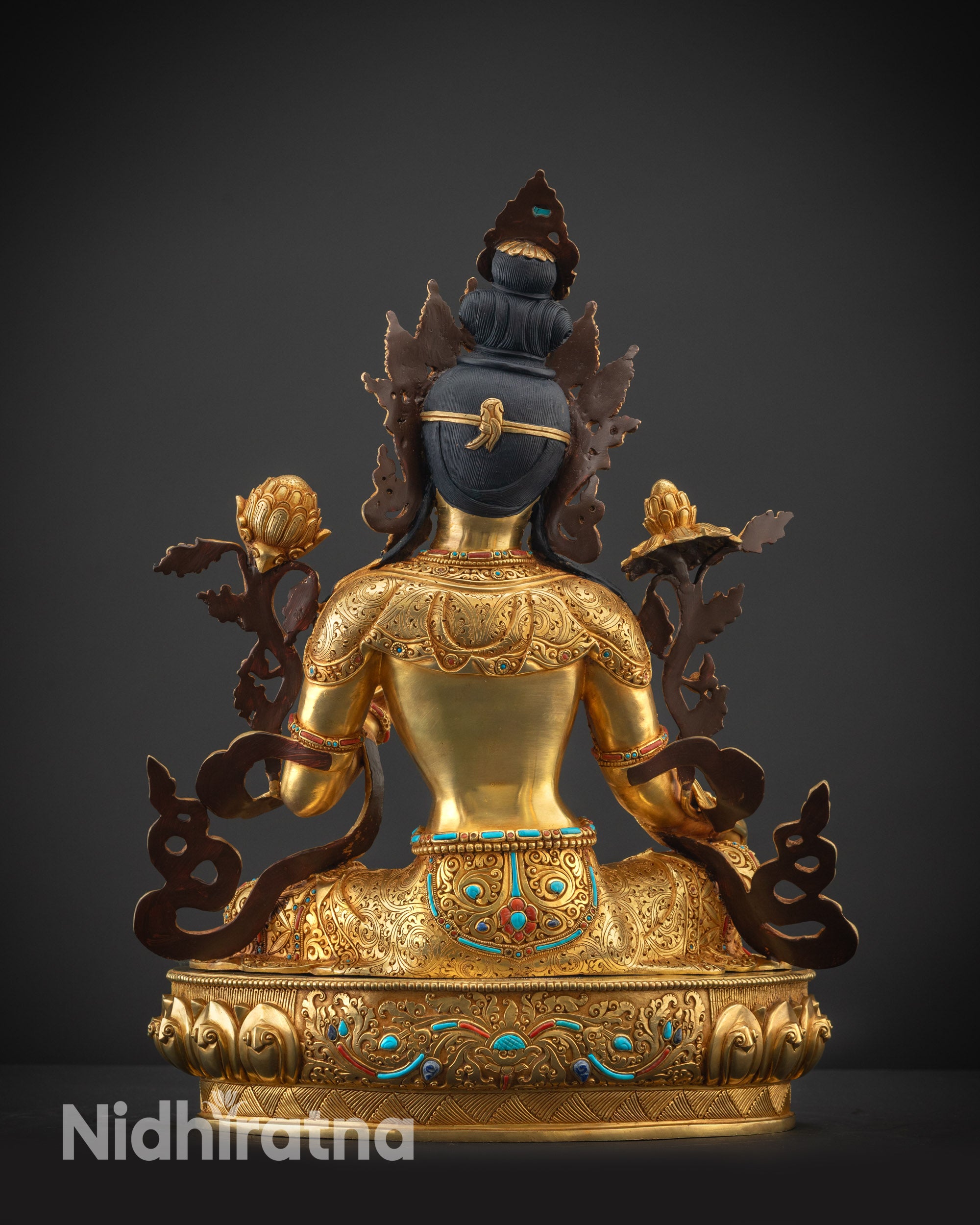 Back view of Green Tara statue showing robe folds and gold-gilded base
