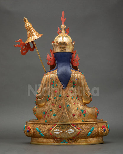 Back view of Guru Norlha Statue displaying white-stone vajra and detailed craftsmanship of robes
