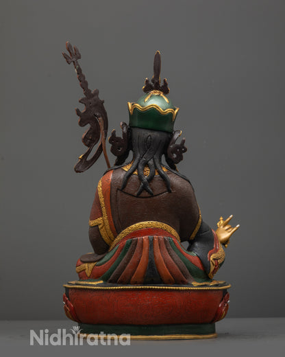 Back view of Guru Padmasambhava statue highlighting gold-plated lotus base and vibrant colors