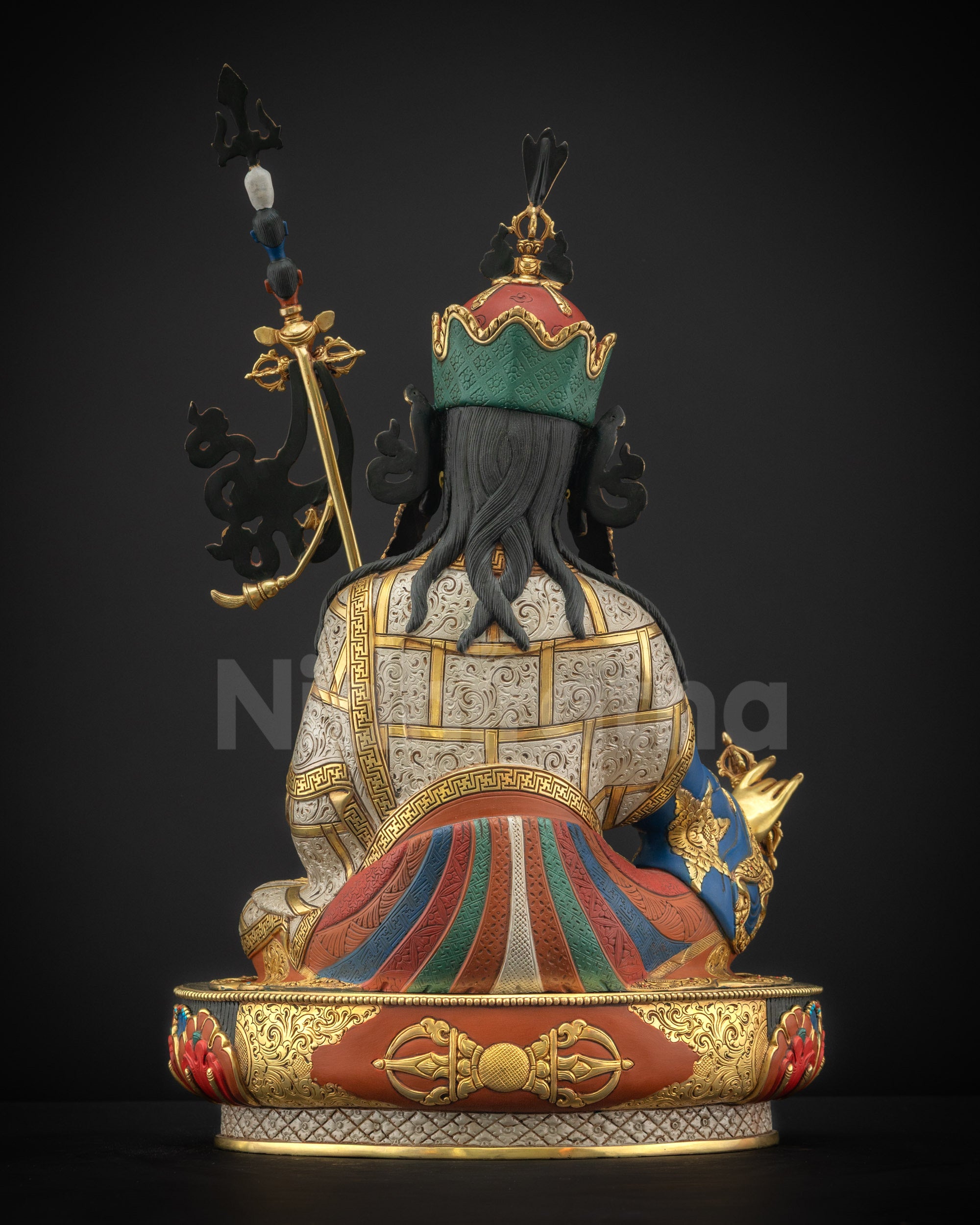 Back view of Guru Padmasambhava statue showing robe patterns and lotus pedestal carving
