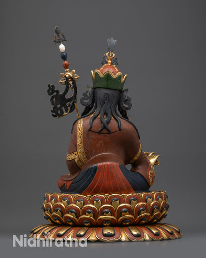 Back view of Guru Padmasambhava statue with intricate carvings, jewelry, and multi-layered lotus base

