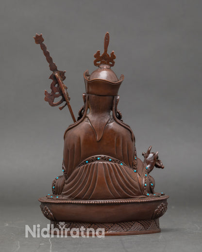 Back view of Guru Rinpoche Buddha statue, detailed lotus seat, Himalayan spiritual art