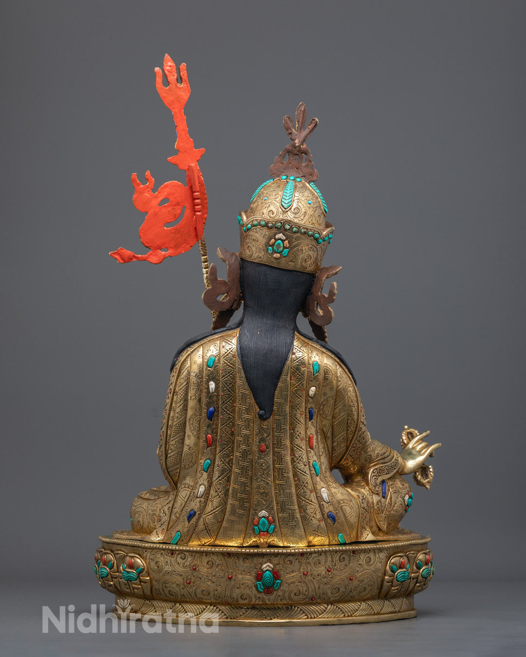 Back view of Guru Rinpoche Sculpture featuring traditional Himalayan motifs and symbolic trident design

