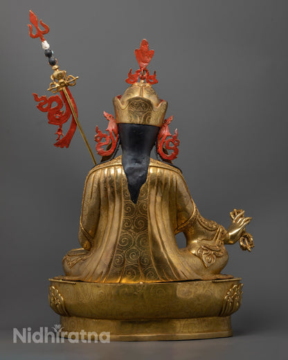 Guru Rinpoche Statue revealing intricate carvings, gold finish, and traditional Himalayan design elements.