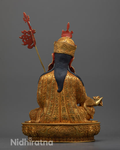Back view of Guru Rinpoche statue showing dharma wheel and deer on lotus base