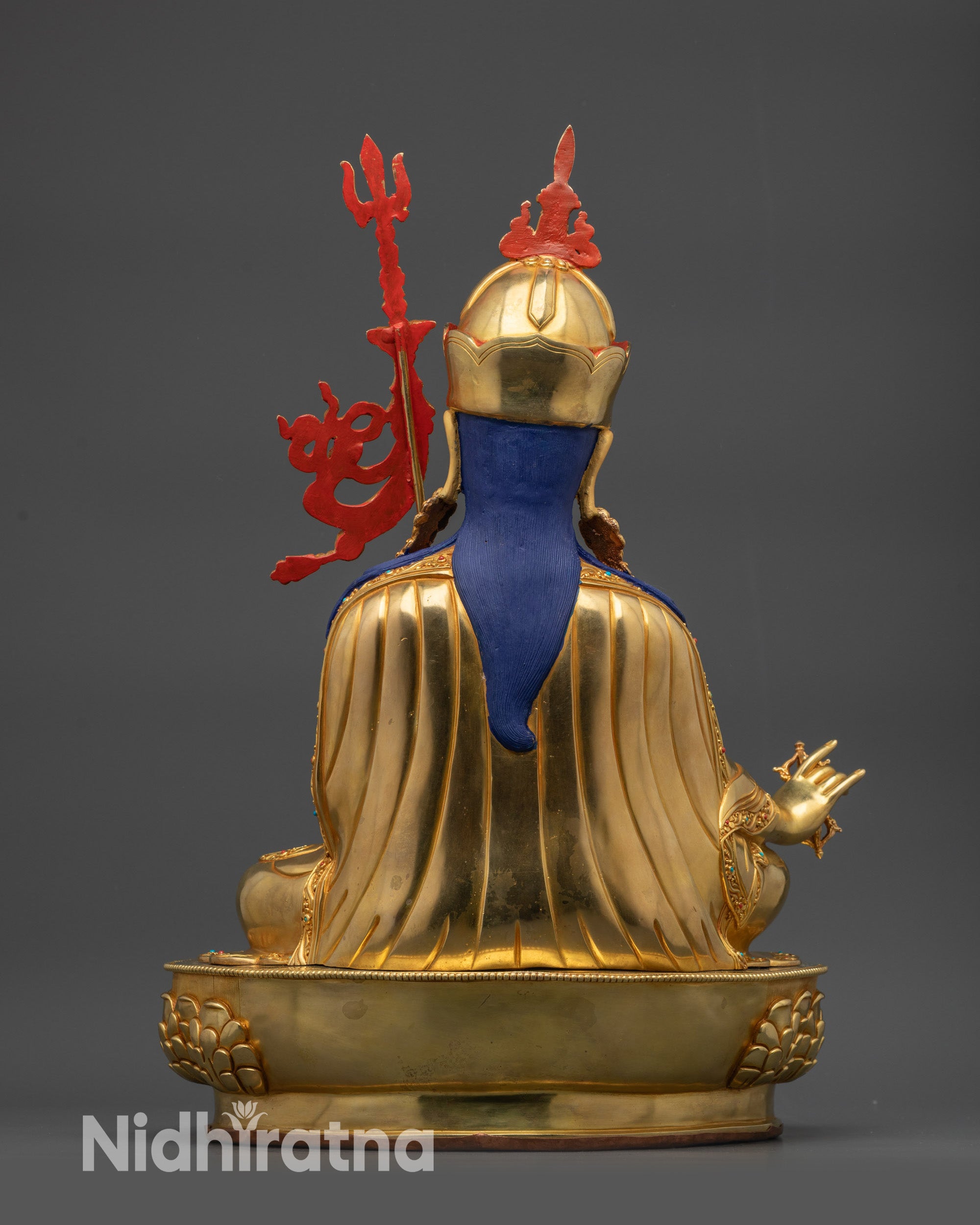 Back view of Guru Rinpoche statue showing intricate robe motif carvings