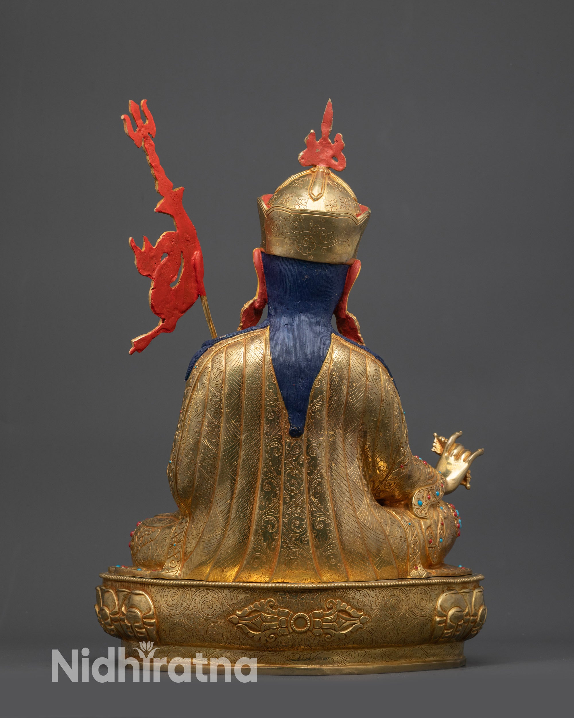 Back view of Guru Rinpoche statue showing intricate robe patterns and craftsmanship