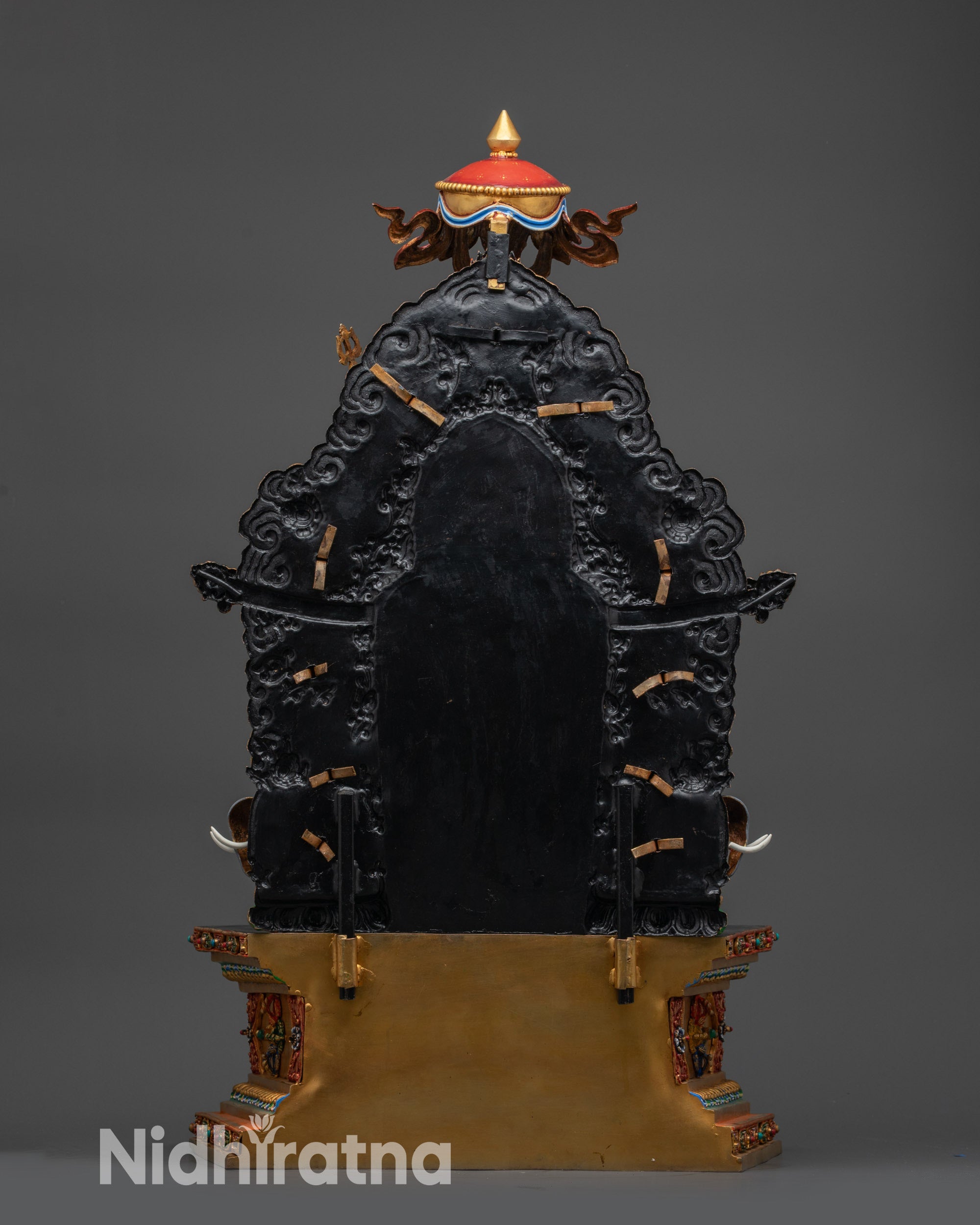 Back view of Guru Rinpoche statue showing ornate torana and throne decorations
