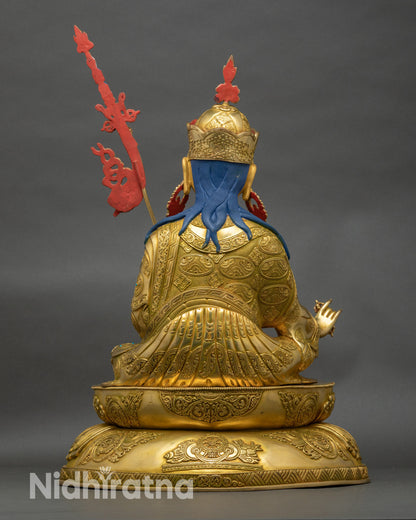 Back view of Guru Rinpoche statue with carved lotus seat and detailed robes