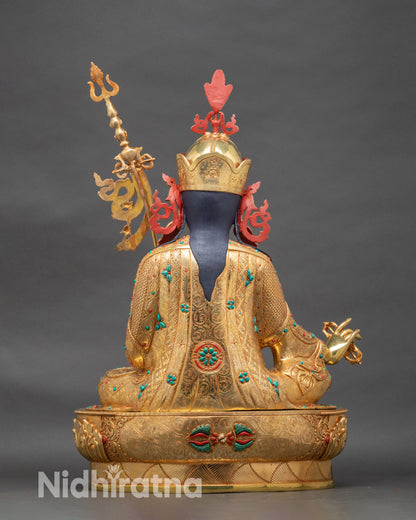 Back view of Guru Rinpoche statue with lotus throne and detailed ceremonial robes