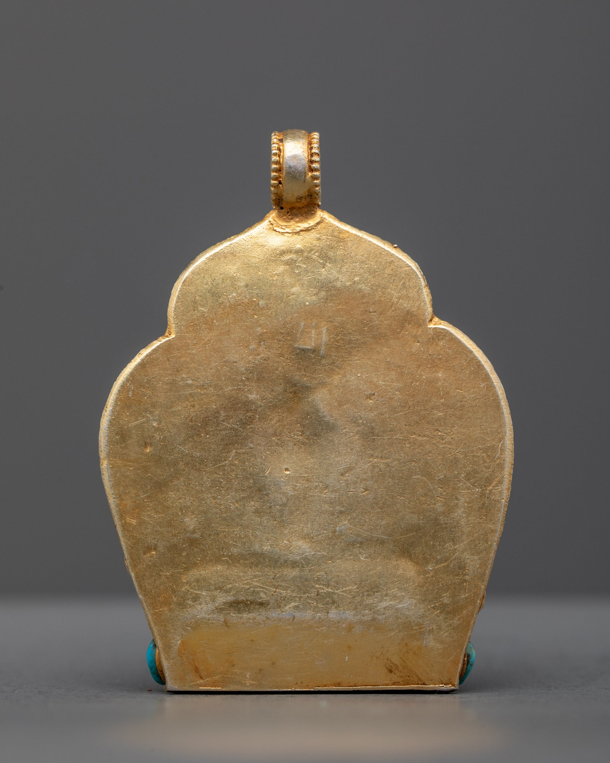 Back view of Handmade Green Tara Locket, showcasing fine craftsmanship and traditional Himalayan gold-gilded metalwork