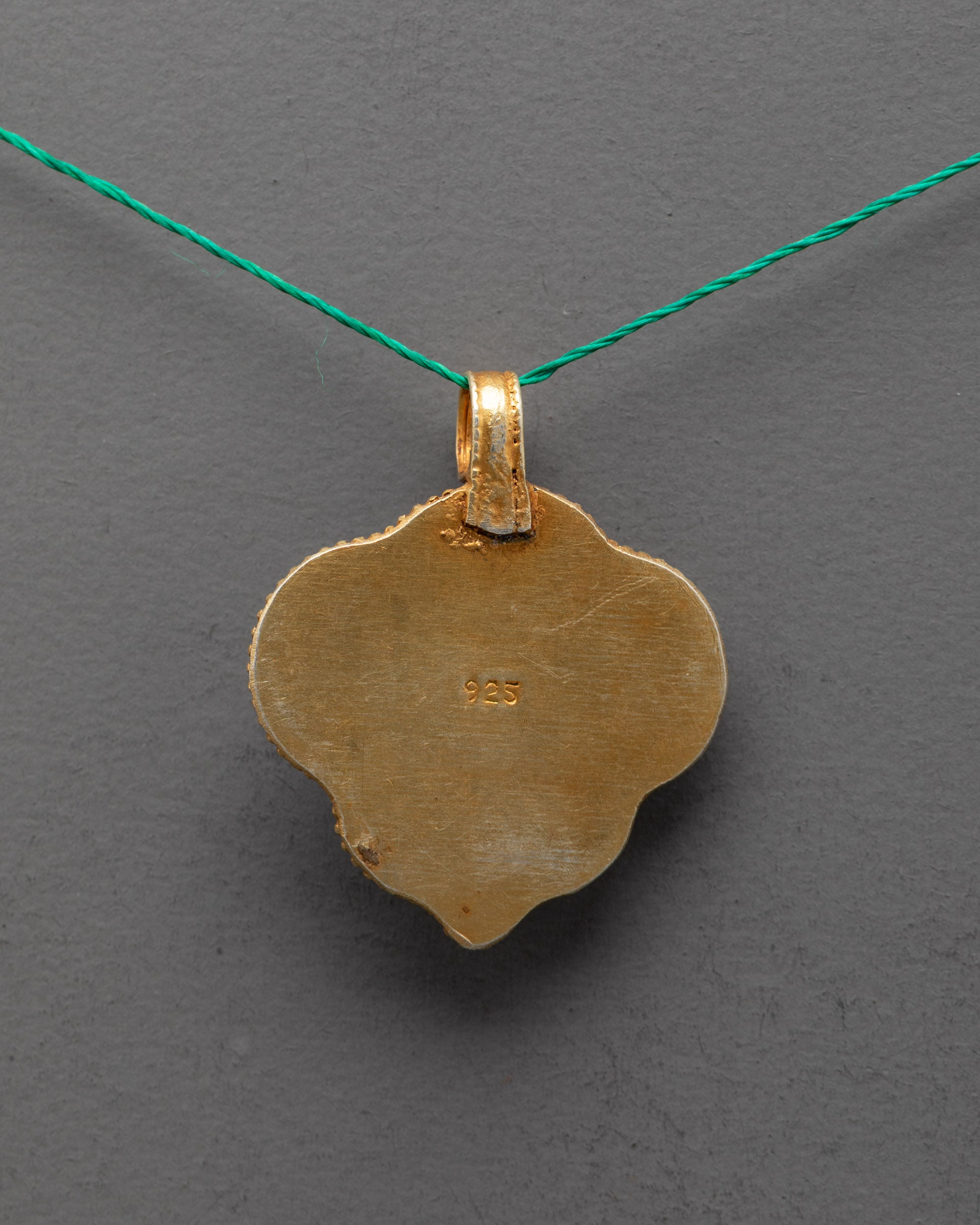 Back view of Handmade Manjushri Locket showcasing fine craftsmanship and traditional Himalayan gold-gilded metalwork.