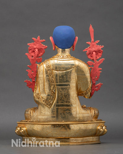 Back view of Je Tsongkhapa copper statue showing lotus base and engraved details