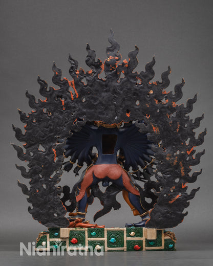 Back view of Kalachakra statue showing lotus base and blazing halo
