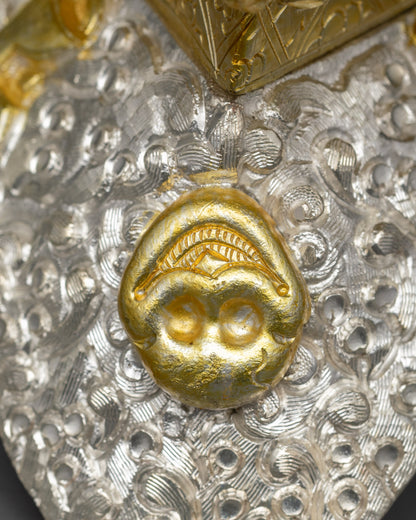 Back view of Kapala with three-sided base and detailed filigree pattern