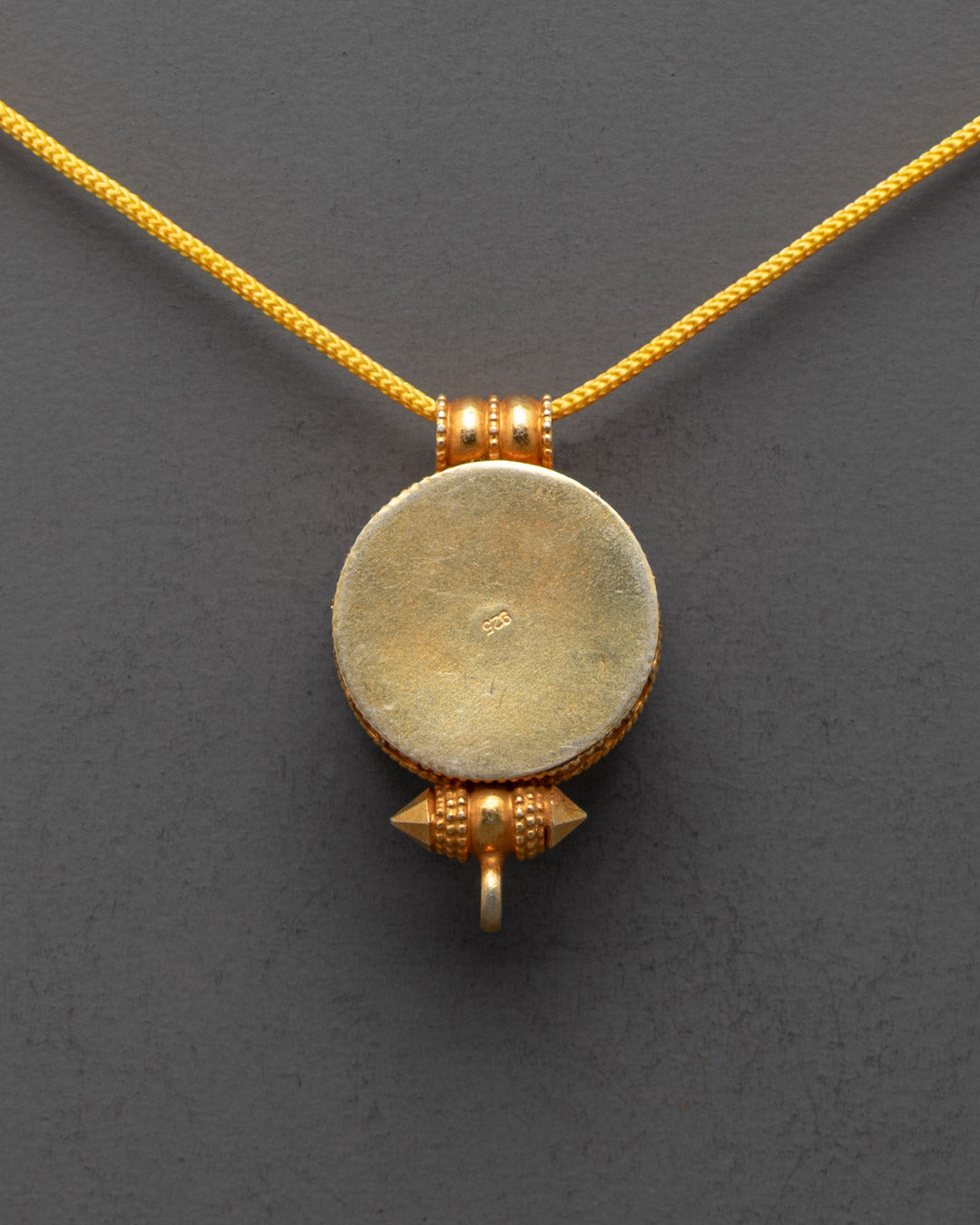 Back view of Khorlo Wheel of Wisdom Locket featuring unique hand-carved patterns