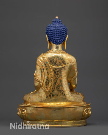 Back view of Lord Gautama Buddha statue showing detailed garments and patterns