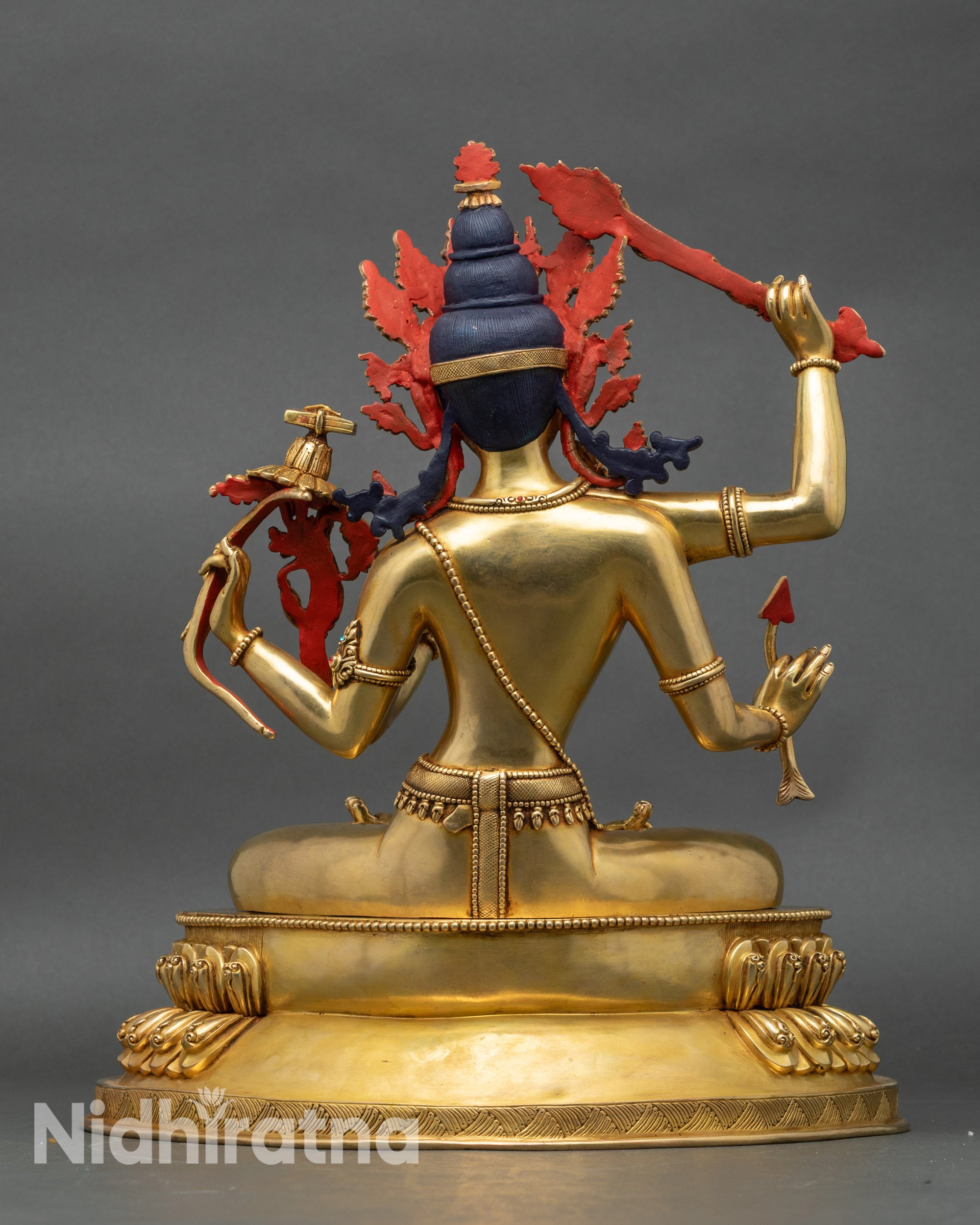 Back view of Maha Manjushri figurine showing ornate robe and gold fire-gilded details