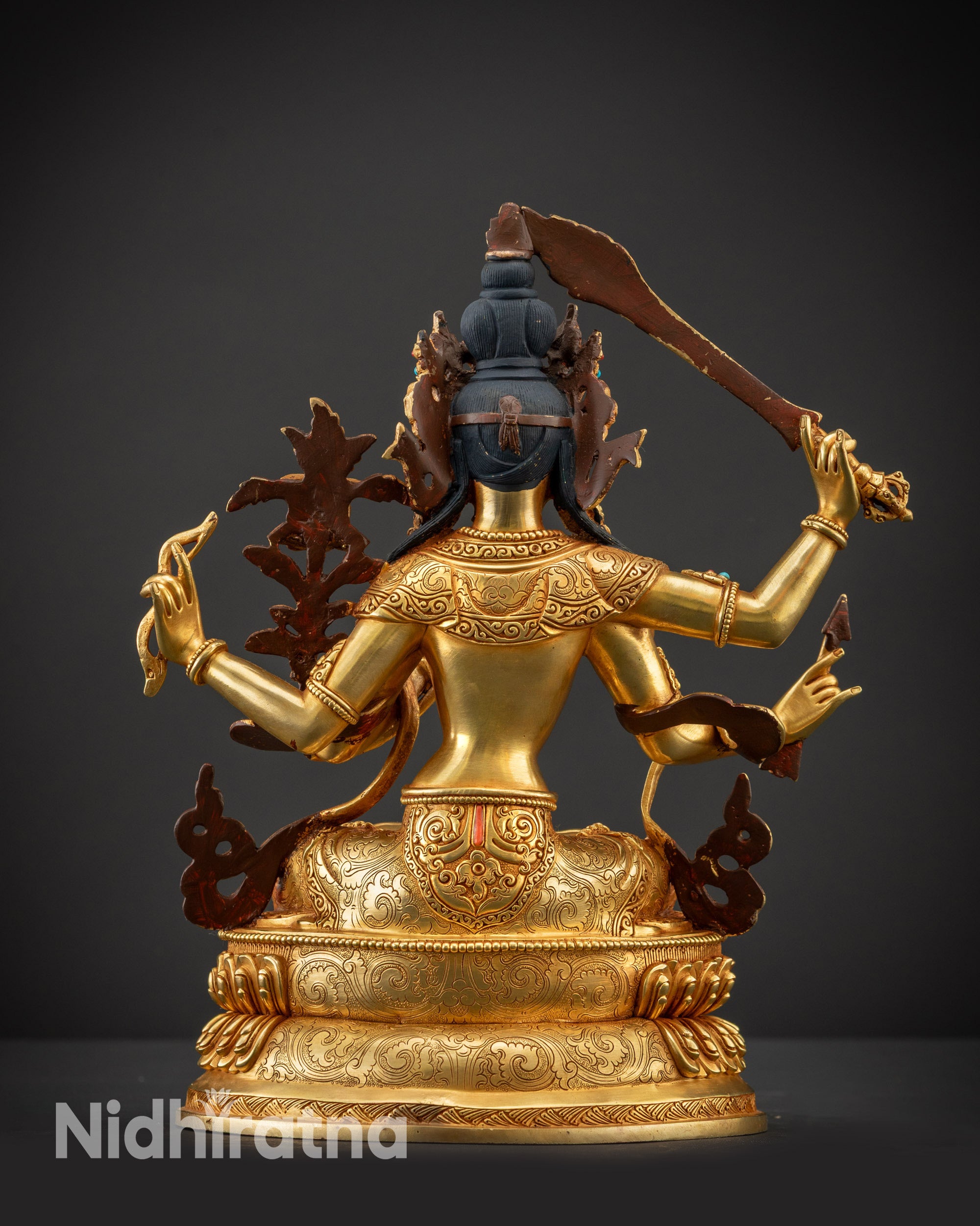 Back view of Maha Manjushri statue showing carved details, robe, and double-layered lotus seat
