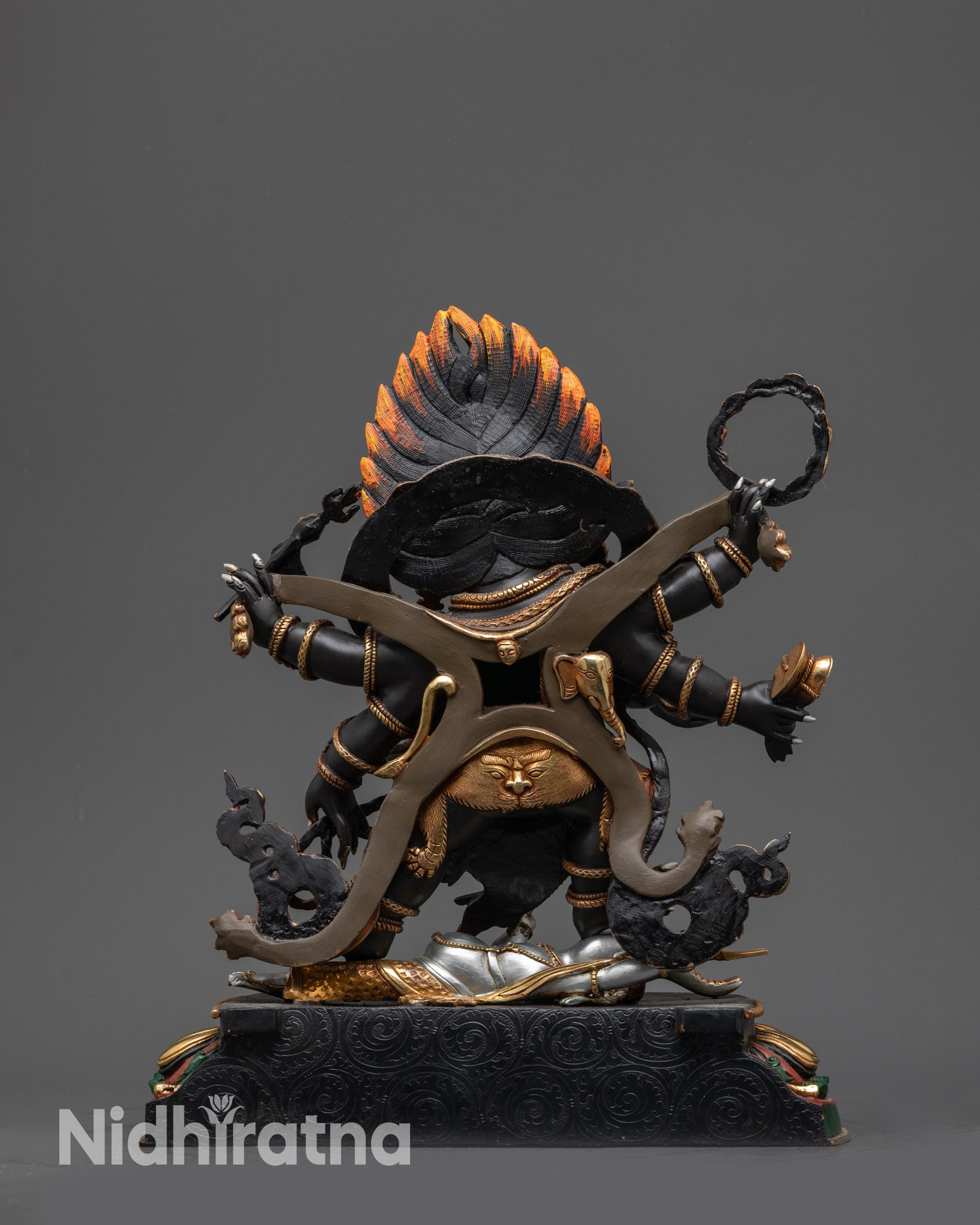 Back view of Mahakala Statue showing patterned garments and gold-plated robe