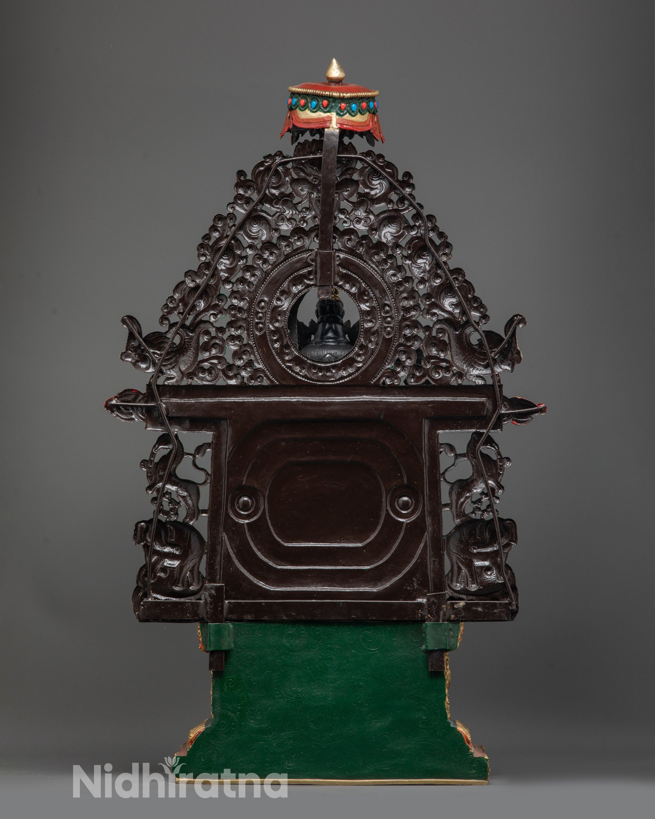 Back view of Maitreya Buddha Statue with halo, parasol, and intricately carved garments