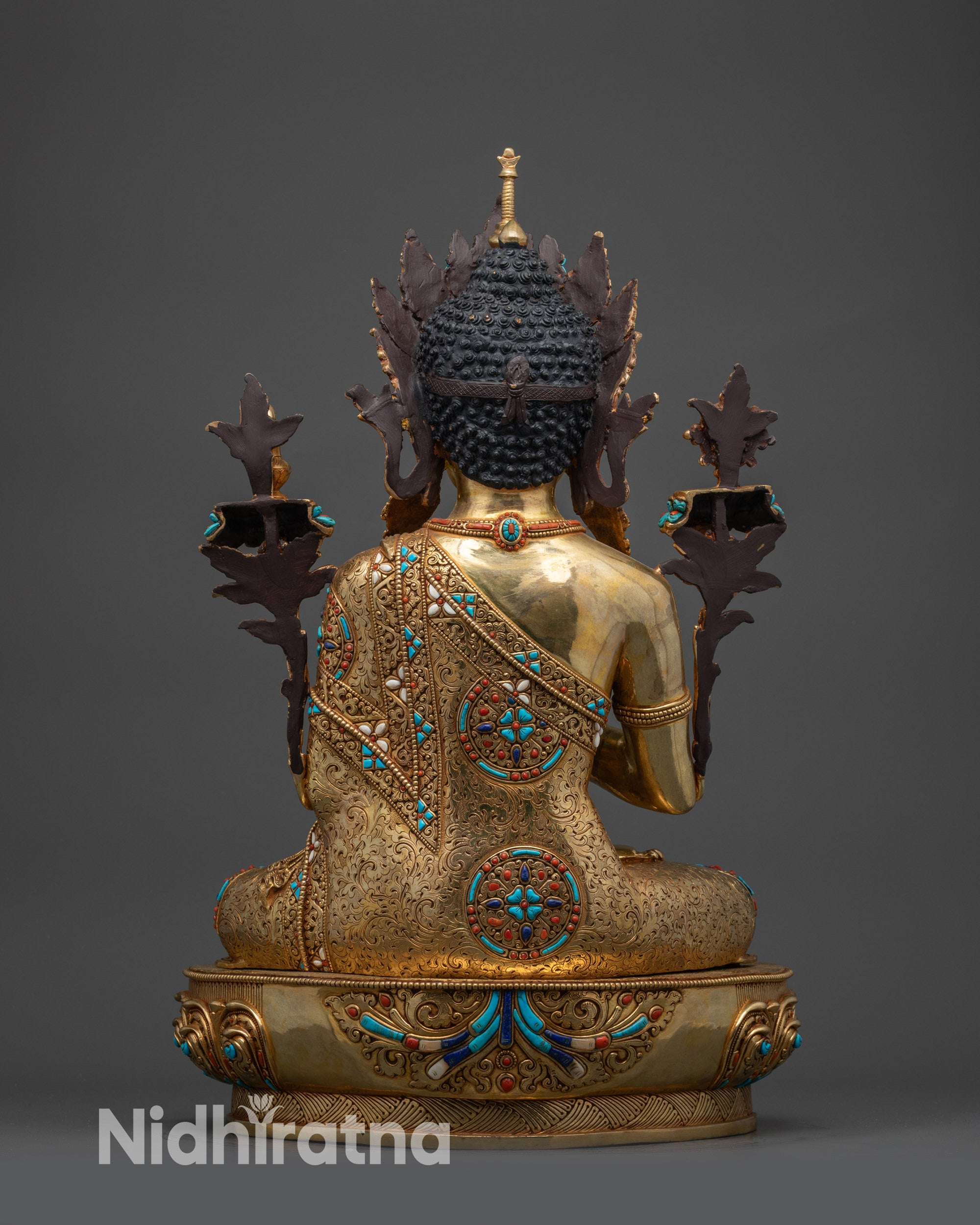 Back view of Maitreya Buddha showing detailed robe patterns and artisan craftsmanship