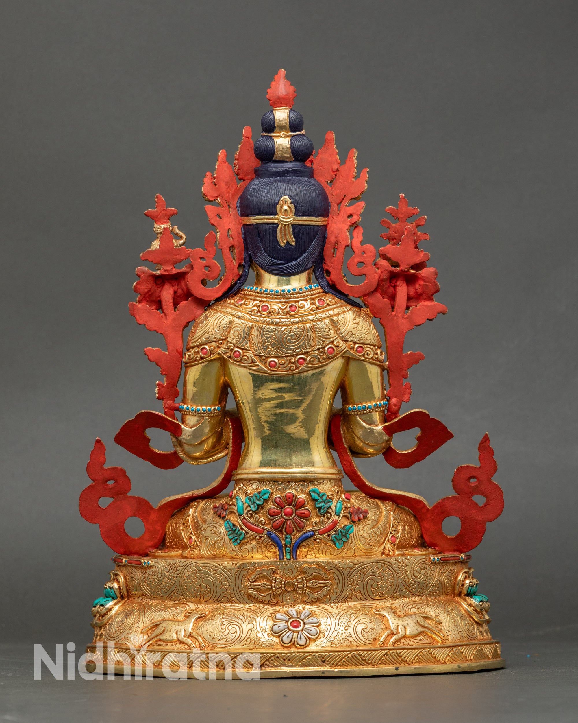 Back view of Maitreya Buddha showing intricately carved robe and decorative motifs