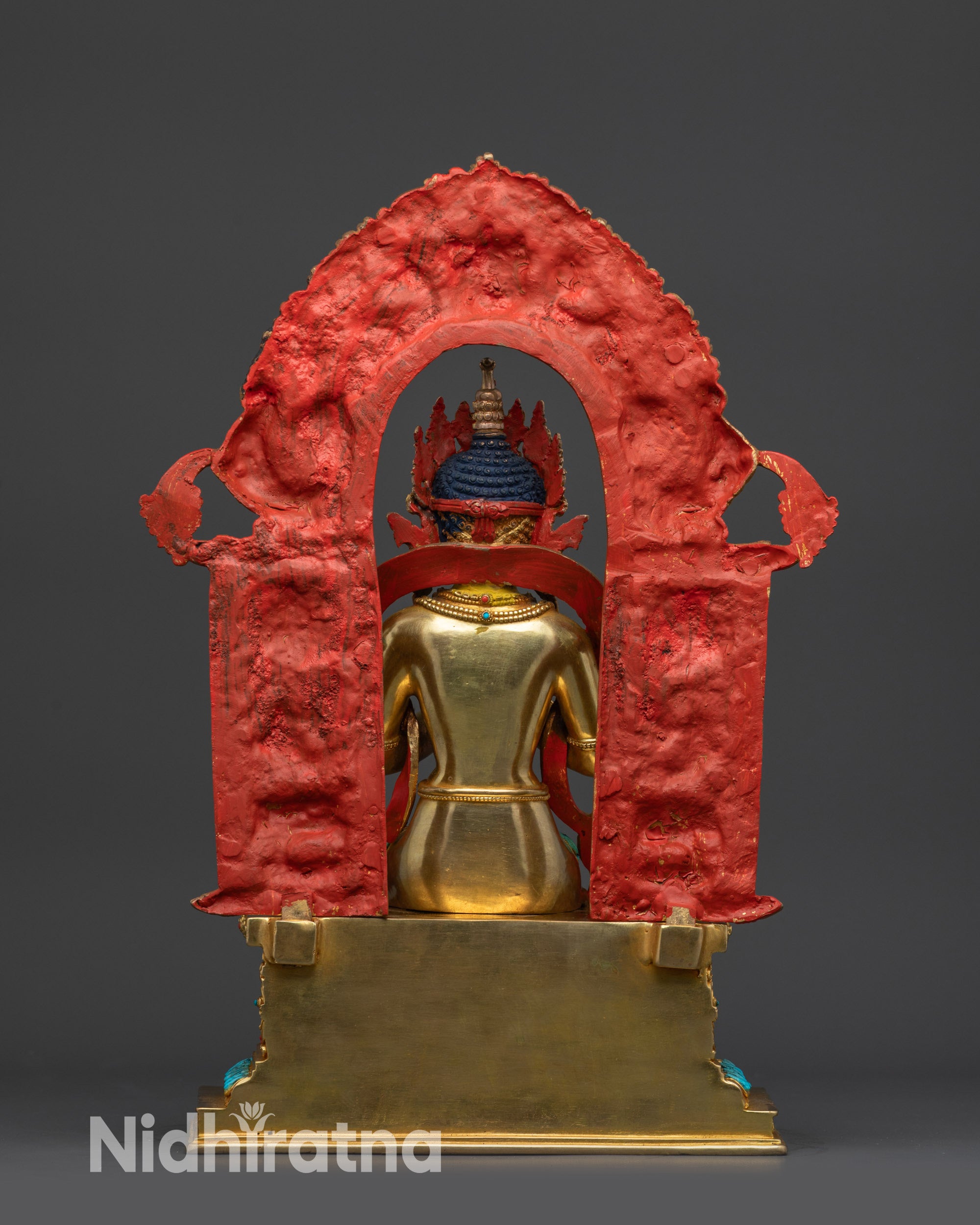 Back view of Maitreya Buddha statue displaying intricate robes and detailed Trona throne