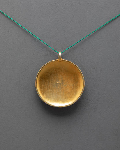 Back view of Mandala Locket highlighting traditional craftsmanship and carved patterns