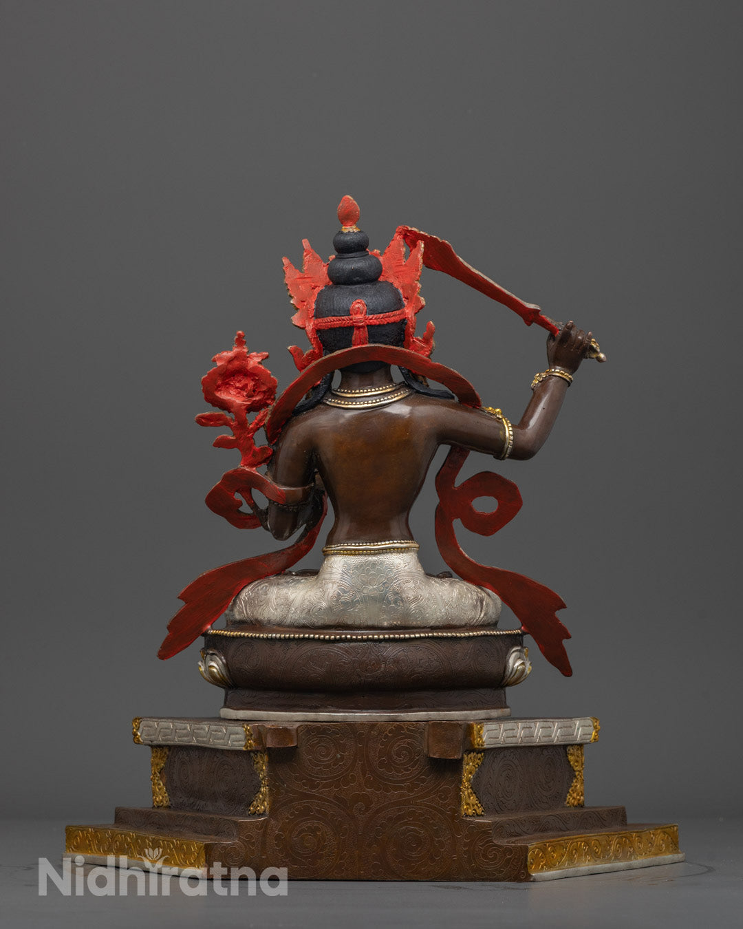 Back view of Manjushri Bodhisattva statue seated on lotus throne