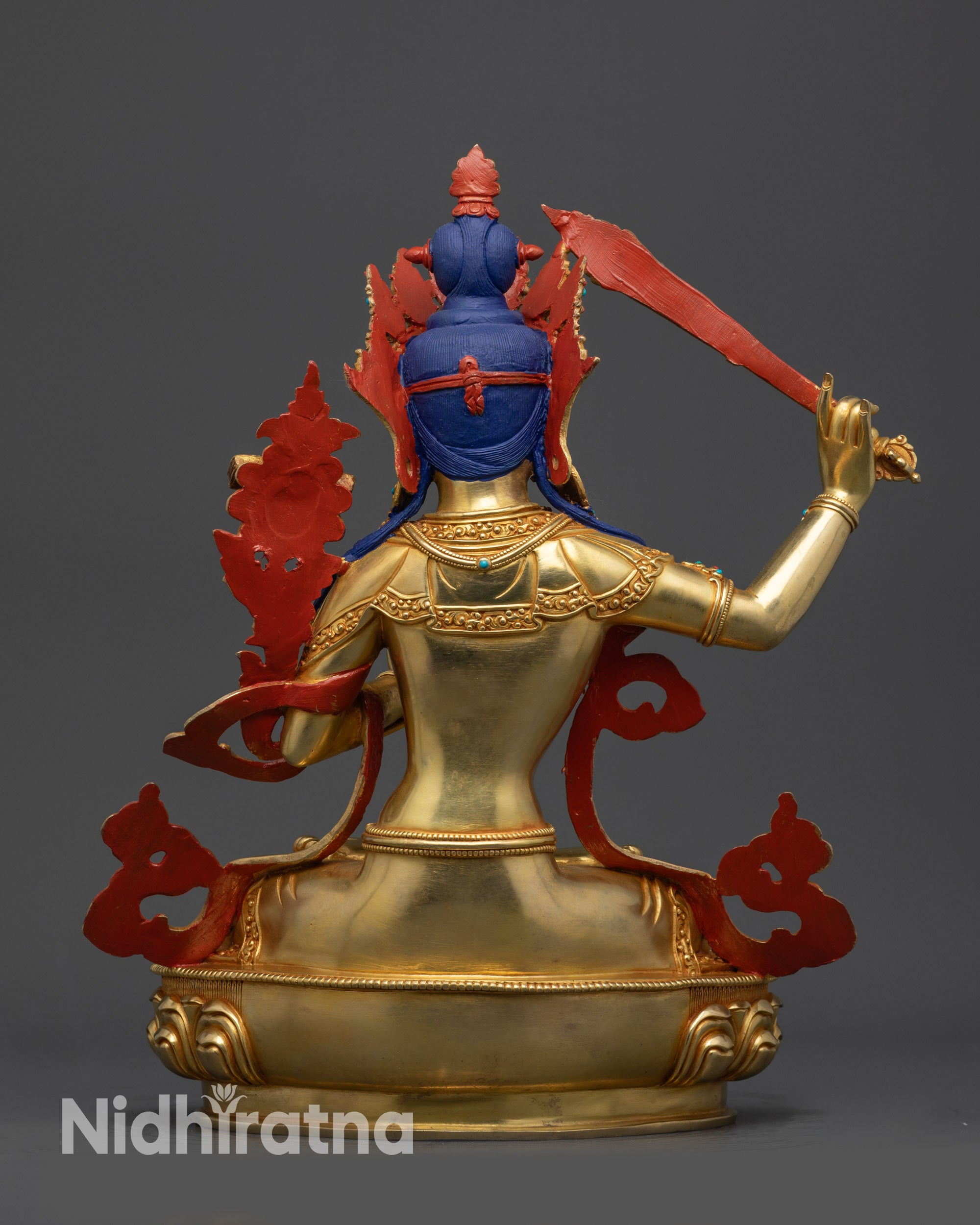 Back view of Manjushri Bodhisattva statue with detailed robe and lotus seat carving
