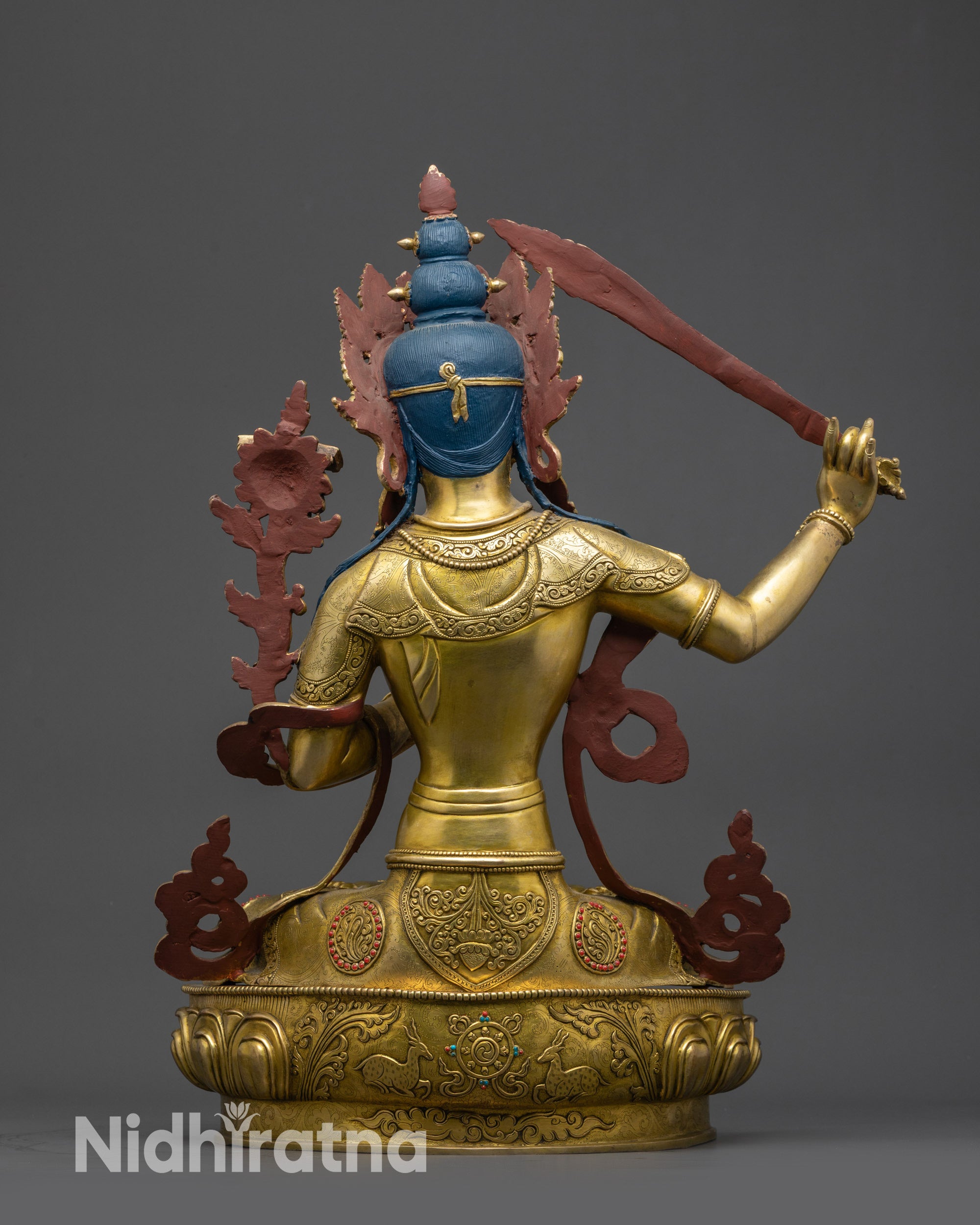 Back view of Manjushri Statue displaying intricately carved twin deer and robe details