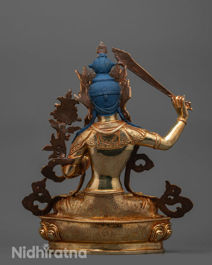 Back view of Manjushri Statue in meditative pose with radiant gold gilding