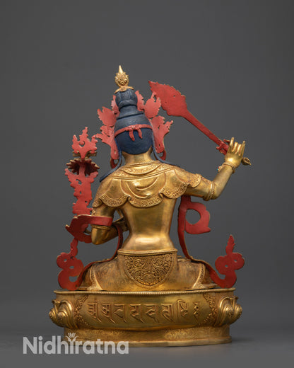 Back view of Manjushri Statue revealing carved robes and lotus seat with sacred mantra