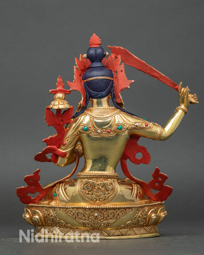 Back view of Manjushri sculpture, lotus pedestal and engraved robes in traditional Nepalese style