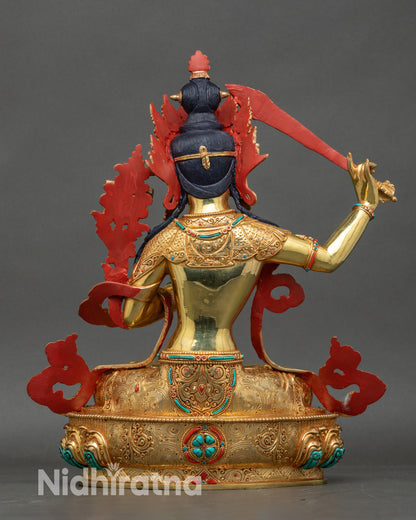 Back view of Manjushri statue, detailed patterns on robes and lotus throne