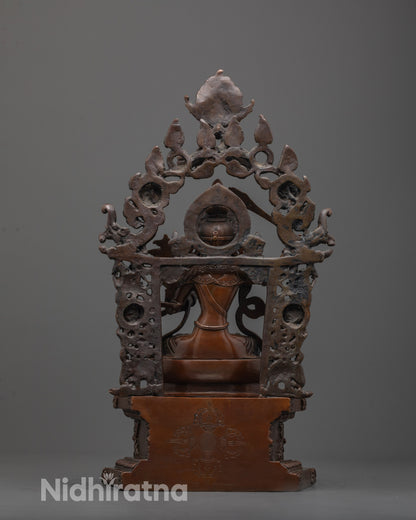 Back view of Manjushri statue highlighting detailed craftsmanship and oxidized copper finish