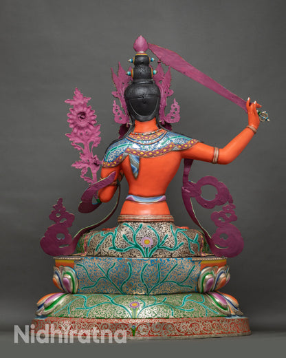 Back view of Manjushri statue showing robe detailing and handcrafted copper form