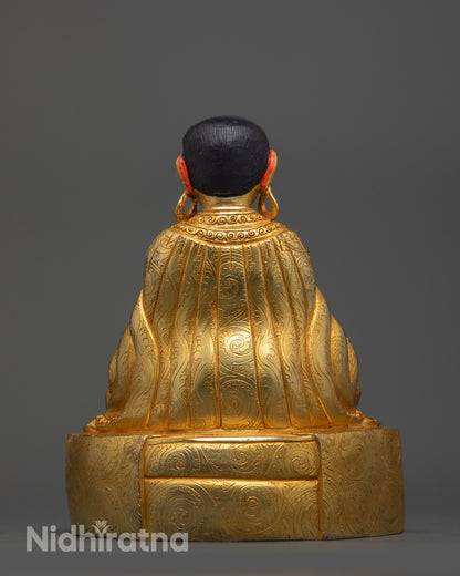 Back view of Marpa Statue with detailed robe patterns and gold fire-gilded body